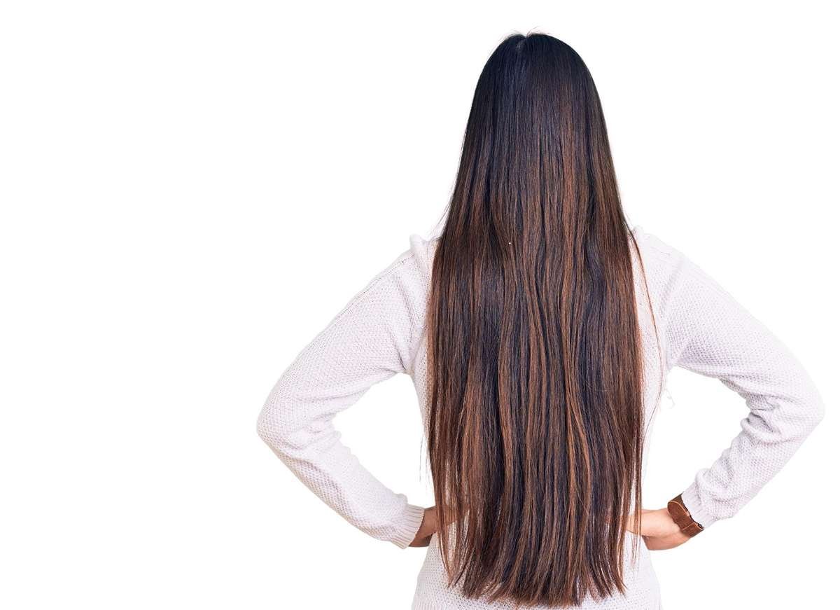Woman wearing a sleek middle part buss down wig with natural shine